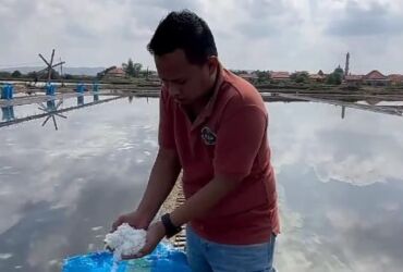 Salah satu petani garam saat memperlihatkan hasil panennya (blok-a.com)