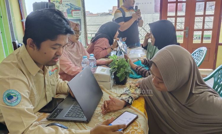 Petugas dari kelurahan lumpur dan Disdukcapil Gresik mengaktivasi IKD di Kantor kelurahan. (Blok-a.com/ivan)